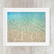 abstract close up of colorful blue tropical water, tan sand and textured waves, available in canvas or art print